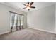 The bedroom features a ceiling fan, large window, and neutral carpet at 3024 Malbec Vly, Acworth, GA 30101