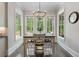 Charming breakfast nook with natural light, features a classic chandelier and views of the lush greenery at 3024 Malbec Vly, Acworth, GA 30101
