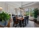 Traditional dining room featuring a stylish light fixture, large window with an outdoor view, and seating for eight at 3024 Malbec Vly, Acworth, GA 30101