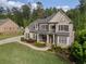 Beautiful brick home with lush landscaping, a covered porch, and an extended driveway at 3024 Malbec Vly, Acworth, GA 30101