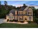 Charming two-story brick home with a landscaped yard, covered porch, and a long driveway at 3024 Malbec Vly, Acworth, GA 30101