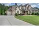 Spacious brick home with a three car garage, landscaped lawn, and welcoming front porch at 3024 Malbec Vly, Acworth, GA 30101