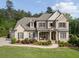 Elegant two-story brick home with a covered front porch and meticulously landscaped front yard at 3024 Malbec Vly, Acworth, GA 30101