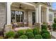 Welcoming front porch with rocking chairs, stone pillars, and beautiful landscaping at 3024 Malbec Vly, Acworth, GA 30101