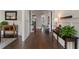 Hallway with paneled walls, hardwood floors, and decoratively appointed occasional tables with greenery at 3024 Malbec Vly, Acworth, GA 30101