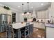 Bright, spacious kitchen with stainless steel appliances, large island with seating, and classic white cabinetry at 3024 Malbec Vly, Acworth, GA 30101