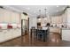 Well-lit kitchen boasts an island with seating, stainless appliances, abundant white cabinetry, and hardwood floors at 3024 Malbec Vly, Acworth, GA 30101