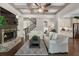 Open-concept living room with a fireplace, coffered ceiling, and modern furnishings, creating an inviting atmosphere at 3024 Malbec Vly, Acworth, GA 30101