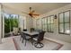 Covered patio with dining table, ceiling fan, string lights, with a view of the manicured backyard at 3024 Malbec Vly, Acworth, GA 30101