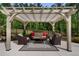 Outdoor seating area under a stylish pergola with comfortable seating and a view of the lush greenery at 3024 Malbec Vly, Acworth, GA 30101