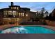 Gorgeous backyard showcasing a well-lit pool and elegant patio with lounge chairs and outdoor dining at 3024 Malbec Vly, Acworth, GA 30101