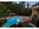 Beautiful pool area featuring a pool, deck, lounge chairs, and lush landscaping at 3024 Malbec Vly, Acworth, GA 30101