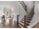Classic staircase with wood treads, white risers, and dark metal balusters leads to the upper level at 3024 Malbec Vly, Acworth, GA 30101