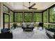 Inviting sunroom featuring many windows, a ceiling fan, and cozy seating, perfect for relaxing and enjoying nature views at 3024 Malbec Vly, Acworth, GA 30101
