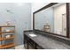 Bathroom featuring a modern vanity, framed mirror, decorative touches and tile walls at 580 Grimsby Ct, Suwanee, GA 30024