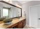 Bathroom featuring a large mirror, granite countertops, and wood cabinets at 580 Grimsby Ct, Suwanee, GA 30024