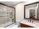 Bathroom with a shower-tub combo and vanity, with a view of the bedroom reflected in the mirror at 580 Grimsby Ct, Suwanee, GA 30024