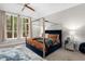 Bedroom featuring a modern bed frame, large windows, and a ceiling fan at 580 Grimsby Ct, Suwanee, GA 30024