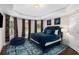 Bedroom featuring tray ceilings, multiple windows, and a large patterned area rug at 580 Grimsby Ct, Suwanee, GA 30024