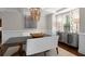 Chic dining room with a contemporary chandelier, a unique buffet, and statement lamps at 580 Grimsby Ct, Suwanee, GA 30024