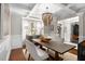 Elegant dining room with coffered ceilings, a stylish chandelier, and ample natural light at 580 Grimsby Ct, Suwanee, GA 30024