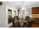 Elegant dining room with chandelier, glass table, and access to a covered porch at 580 Grimsby Ct, Suwanee, GA 30024