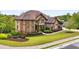 Beautiful two-story home featuring a well-manicured lawn, mature trees, brick and siding exterior at 580 Grimsby Ct, Suwanee, GA 30024