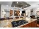 View of the kitchen island with gas range, opening to the living and dining room at 580 Grimsby Ct, Suwanee, GA 30024