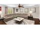Living room with a large sectional sofa, marble coffee table, and stylish decor at 580 Grimsby Ct, Suwanee, GA 30024