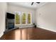 Bright living room showcasing a fireplace, dark floors, and natural light from large windows at 580 Grimsby Ct, Suwanee, GA 30024