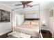 Bedroom with a stylish four-poster bed, hardwood floors and an elegant ceiling fan at 580 Grimsby Ct, Suwanee, GA 30024
