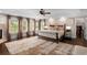 Spacious main bedroom with dark hardwood floors, fireplace, windows and a decorative ceiling at 580 Grimsby Ct, Suwanee, GA 30024