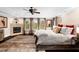Spacious main bedroom with a tray ceiling, decorative fireplace, a large window, and stylish furnishings at 580 Grimsby Ct, Suwanee, GA 30024