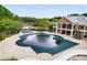 An outdoor pool with cover and a built-in water slide in a backyard at 580 Grimsby Ct, Suwanee, GA 30024