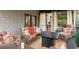 Relaxing porch with wicker furniture, a fire pit table, and privacy curtains at 580 Grimsby Ct, Suwanee, GA 30024