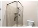 Bathroom featuring a glass shower with tile surround, convenient shelving and fixtures at 580 Grimsby Ct, Suwanee, GA 30024