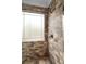 Shower featuring decorative tile surround and a glass door at 580 Grimsby Ct, Suwanee, GA 30024