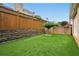 Well-maintained backyard with lush artificial grass and a charming, sculpted tree as a focal point at 6355 Glen Oaks Ln, Atlanta, GA 30328