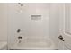 Clean white tub and tiled shower, complemented by an elegant niche at 6355 Glen Oaks Ln, Atlanta, GA 30328