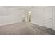 Spacious bedroom with neutral carpet, white walls, and door to bathroom at 6355 Glen Oaks Ln, Atlanta, GA 30328