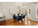 Dining area with modern light fixture, hardwood floors and next to the well-lit kitchen area at 6355 Glen Oaks Ln, Atlanta, GA 30328