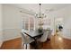 Elegant dining room features hardwood floors, modern chandelier, and stylish decor at 6355 Glen Oaks Ln, Atlanta, GA 30328