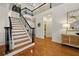 Bright foyer with hardwood floors, a staircase with black railings, and an open layout, perfect for welcoming guests at 6355 Glen Oaks Ln, Atlanta, GA 30328