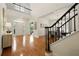 Inviting foyer with hardwood floors, a staircase, and a view into the dining area, creating an open feel at 6355 Glen Oaks Ln, Atlanta, GA 30328