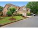 Beautifully landscaped brick home with a two-car garage and well-maintained lawn in a suburban setting at 6355 Glen Oaks Ln, Atlanta, GA 30328