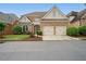Charming brick home featuring a two-car garage, manicured lawn, and inviting landscaping in a desirable neighborhood at 6355 Glen Oaks Ln, Atlanta, GA 30328