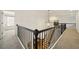 Open hallway with black railing overlooks staircase, enhancing the home's design at 6355 Glen Oaks Ln, Atlanta, GA 30328