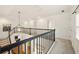 Open hallway with decorative chandelier overlooks staircase, enhancing the home's design at 6355 Glen Oaks Ln, Atlanta, GA 30328