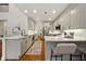 Modern kitchen with stainless steel appliances, breakfast bar, and white countertops and cabinetry at 6355 Glen Oaks Ln, Atlanta, GA 30328