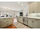 Open concept kitchen with stainless appliances, tile backsplash, and eat-in area leading to living room at 6355 Glen Oaks Ln, Atlanta, GA 30328